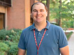 Robert Bernhard in a blue polo standing on Academic Row.